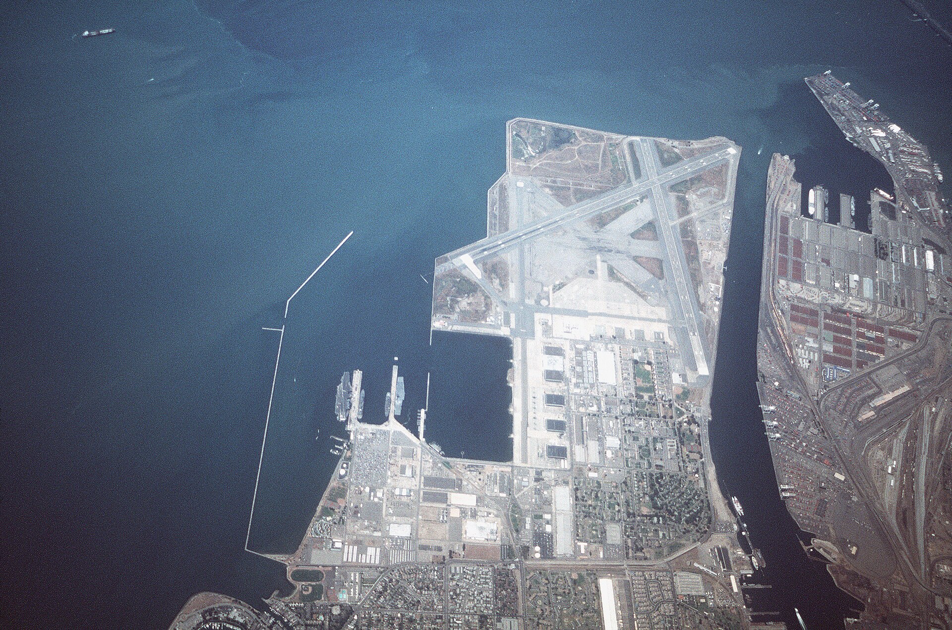 Aerial view of Naval Air Station Alameda in 1995, showing runways, hangars, and the Seaplane Lagoon